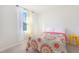 Bedroom featuring a queen bed, window, and yellow stool at 80 Bella Vita Way, Angier, NC 27501