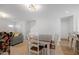 Dining area with a wooden table and white chairs, near the kitchen and living room at 80 Bella Vita Way, Angier, NC 27501