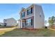 Two-story house with gray siding, and a landscaped yard at 80 Bella Vita Way, Angier, NC 27501