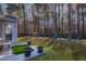 Spacious backyard with a wooden fence and lush green trees at 9108 Erinsbrook Dr, Raleigh, NC 27617