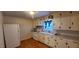 Kitchen features white cabinets and wood flooring at 1404 N Main St, Roxboro, NC 27573