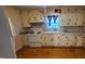 White kitchen with wood floors and appliances at 1404 N Main St, Roxboro, NC 27573