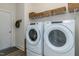 Laundry room with Whirlpool washer and dryer, and shelving at 155 Shelby Meadow Ln, Angier, NC 27501