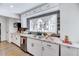 Modern kitchen with granite countertops, white cabinets, and a farmhouse sink at 211 E Lizzie St, Selma, NC 27576