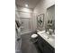 Clean bathroom with gray vanity, shower/tub combo, and neutral tile floors at 2243 Horton Park Drive, Apex, NC 27539