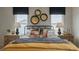 Stylish bedroom featuring a mustard yellow duvet, patterned pillows, and geometric wallpaper at 2243 Horton Park Drive, Apex, NC 27539