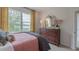 Bedroom with queen bed, dresser, and yellow curtains at 2243 Horton Park Drive, Apex, NC 27539