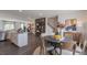 Open concept dining room with kitchen and wood flooring at 2243 Horton Park Drive, Apex, NC 27539
