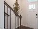 Second view of entryway with staircase, dark hardwood floors, and wall art at 2243 Horton Park Drive, Apex, NC 27539
