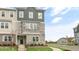 Three-story townhome with stone and siding exterior, steps leading to the entrance, and landscaping at 2243 Horton Park Drive, Apex, NC 27539