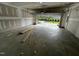 Unfinished garage with open door, showing a view of the exterior and some building materials at 2243 Horton Park Drive, Apex, NC 27539