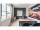 Modern home office with wood desk, large wall art, and window with curtains at 2243 Horton Park Drive, Apex, NC 27539