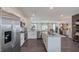 Open concept kitchen with island and stainless steel appliances at 2243 Horton Park Drive, Apex, NC 27539