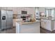 Modern kitchen with stainless steel appliances and large island at 2243 Horton Park Drive, Apex, NC 27539