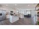 Open concept kitchen with island, stainless steel appliances, and living room view at 2243 Horton Park Drive, Apex, NC 27539