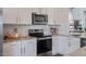 Modern kitchen with white cabinets and stainless steel appliances at 2243 Horton Park Drive, Apex, NC 27539