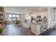 Open kitchen with island, white cabinets, and breakfast nook at 2243 Horton Park Drive, Apex, NC 27539