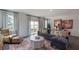 Spacious living room with L-shaped sectional sofa and access to deck at 2243 Horton Park Drive, Apex, NC 27539