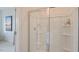 Clean and bright shower with glass enclosure and built-in shelving at 2243 Horton Park Drive, Apex, NC 27539