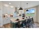 Modern kitchen with green island, white cabinets and stainless steel appliances at 23 Barrow Ct, Angier, NC 27501