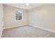 Spacious bedroom with ceiling fan and window, grey carpet at 25 Porters Glen Pl, Durham, NC 27713