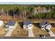 Three two-story houses with attached garages and wooded backdrop at 274 E Boulder Road, Henderson, NC 27537