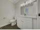Updated bathroom with white vanity and modern fixtures at 302 N Montreal Ct, Cary, NC 27511