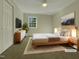 Virtually staged bedroom with light wood bed frame and neutral decor at 302 N Montreal Ct, Cary, NC 27511