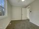 Spacious bedroom with carpet, window, and access to other rooms at 302 N Montreal Ct, Cary, NC 27511