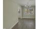 Bright dining room with hardwood floors and chandelier, offering access to backyard at 302 N Montreal Ct, Cary, NC 27511