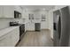 Modern kitchen with white cabinets, stainless steel appliances, and white tile backsplash at 302 N Montreal Ct, Cary, NC 27511