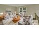 Virtually staged living room with light gray sofa and armchairs at 302 N Montreal Ct, Cary, NC 27511