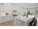 Spacious kitchen with white cabinetry, quartz countertops and a large island at 366 Davis Love Dr, Chapel Hill, NC 27517