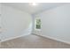 Simple bedroom with carpeted floor and a window providing natural light at 51 Sunburst Ct, Fuquay Varina, NC 27526