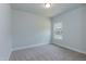 Well-lit bedroom with a window overlooking neighboring houses at 51 Sunburst Ct, Fuquay Varina, NC 27526