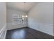 Formal dining room with wainscoting and hardwood floors at 51 Sunburst Ct, Fuquay Varina, NC 27526