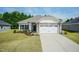 New construction home with stone accents, two-car garage, and landscaped lawn at 51 Sunburst Ct, Fuquay Varina, NC 27526