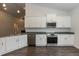 Modern kitchen with stainless steel appliances and white cabinets at 51 Sunburst Ct, Fuquay Varina, NC 27526