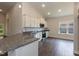 Modern kitchen with white cabinets, granite countertops, and stainless steel appliances at 51 Sunburst Ct, Fuquay Varina, NC 27526