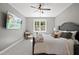Bright bedroom with a king-size bed and mounted TV at 517 Shawnee Dr, Louisburg, NC 27549
