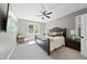 Spacious bedroom with a large bed, ceiling fan, and mounted TV at 517 Shawnee Dr, Louisburg, NC 27549