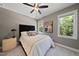 Elegant bedroom with a luxurious bed and natural light at 517 Shawnee Dr, Louisburg, NC 27549