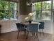 Dining room with round table and four blue chairs, and large windows at 517 Shawnee Dr, Louisburg, NC 27549