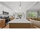 Modern kitchen with white cabinets, a large island, and stainless steel appliances at 517 Shawnee Dr, Louisburg, NC 27549