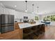 Modern kitchen with white cabinets, large island, and stainless steel appliances at 517 Shawnee Dr, Louisburg, NC 27549