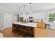 Modern kitchen with island, stainless steel appliances, and white shaker cabinets at 517 Shawnee Dr, Louisburg, NC 27549