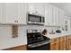 Stainless steel appliances and light wood cabinets in this kitchen at 517 Shawnee Dr, Louisburg, NC 27549