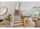 Modern staircase with metal railing leading to the upper level at 517 Shawnee Dr, Louisburg, NC 27549