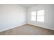 Unfurnished bedroom with neutral carpet and large windows at 54 Northwood Dr, Fuquay Varina, NC 27526