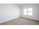 Empty bedroom with neutral carpet and white walls, ready for personalization at 54 Northwood Dr, Fuquay Varina, NC 27526